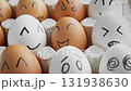 Funny eggs with smiling faces. Happy and unhappy faces. Chicken egg in container 131938630