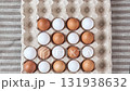 Stop motion of chicken eggs are placed in cardboard cells. Brown and white eggs. 131938632