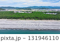 Aerial drone shot of the blue sea and white clouds spreading out from the majestic gravel beach of Enjugahama in Wakayama towards the windbreak forest Aerial drone shot of the blue sea and white clouds spreading out from the majestic gravel beach of Enjugahama in Wakayama towards the windbreak forest 131946110