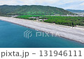 Aerial drone shot of the majestic pebbled beach of Enjugahama in Wakayama, with blue sea and white clouds. Aerial drone shot of the majestic pebbled beach of Enjugahama in Wakayama, with blue sea and white clouds. 131946111