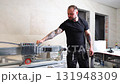 Construction Worker Using Tile Saw Cutting Machine for Home Improvement Project 131948309
