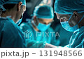 A focused surgical team wearing masks and scrubs performs a complex operation in a well-lit operating room. 131948566