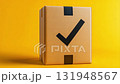 A checked delivery box against a vibrant yellow background, symbolizing successful shipping and fulfillment. 131948567