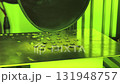 Interesting process of applying a coating through a special technique under green light in a lab environment 131948757