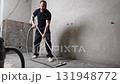 Construction worker vacuuming dust and debris after laying tiles in bathroom 131948772