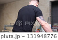 Construction worker using tile saw cutting machine preparing ceramic tiles for bathroom renovation 131948776