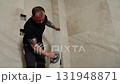 Construction Worker Installing Large Travertine Tiles in Modern Bathroom 131948871