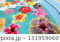 Colorful hibiscus flowers floating on the water - Relaxing video of a tropical resort 131959060
