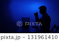 Man silhouetted tossing crumpled paper into trash can 131961410