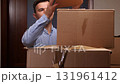 Man stacking cardboard boxes moving new home 131961412