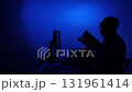 Man silhouette working on computer with blue light 131961414