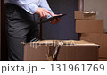 Delivery man managing logistics using digital tablet 131961769