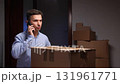 Stressed man talking on phone during apartment move 131961771