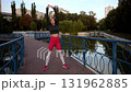 Outdoor Fitness Routine in Urban Park: Woman Stretching by the Water 131962885