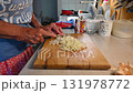 Woman cutting and preparing vegetables at home in the kitchen. Concept for cooking and food preparation. 131978772