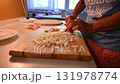 Woman cutting and preparing vegetables at home in the kitchen. Concept for cooking and food preparation. 131978774