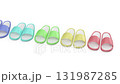 Row of five pairs of rubber slides in different colors on white background 131987285
