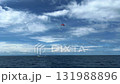 Two people fly on a parachute over a sky-blue sea on two domes towed by a boat. parasailing 131988896
