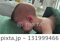 Peaceful baby sleeping on a green blanket 131999466