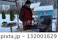 A man grills meat in winter. close-up. Winter picnic, outdoor recreation. 132001629