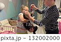 Children sharing happiness while playing with a kitten on the couch in their cozy living room. 132002000