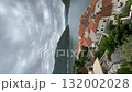 Scenic coastal village with historic stone buildings and red roofs under cloudy sky video 132002028