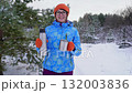Winter hike, smiling hiker enjoying hot beverage in snowy forest 132003836