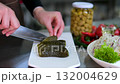 Process of preparing traditional pickled vegetables sliced cucumbers placed beside salted tomatoes plate with jar of marinated mushrooms creating healthy homemade appetizer rich in natural probiotics 132004629