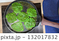 Unusual green spinach or broccoli fritters are pan-fried until crispy, offering a tasty and healthy snack or appetizer. 132017832