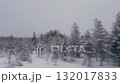 View from the car window on the winter road. The wires of the high-voltage power line stretch along the winter road. 132017833