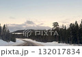 View from the car window on the winter road. The wires of the high-voltage power line stretch along the winter road. 132017834