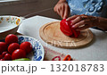 Woman cutting and preparing vegetables at home in the kitchen. Concept for cooking and food preparation. 132018783