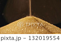 Close-up photograph of golden glittering sand leaking out of an hourglass. 132019554