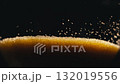 Close-up photograph of golden glittering sand leaking out of an hourglass. 132019556