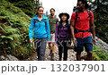 A group of people walking on a trail in the woods 132037901