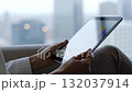 A person sitting on a couch using a tablet computer 132037914