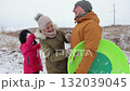 Friendly family of mother father and daughter cleans from snow on winter day 132039045