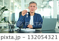 Successful Businessman Proudly Shows New House Keys in Modern Office 132054321