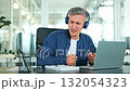 Frustrated Businessman Concentrates on Laptop in Modern Office 132054323