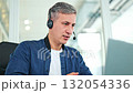 Focused Businessman With Headset Working Remotely From Modern Office 132054336