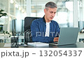 Confident Professional Male Smiling at Modern Office Desk 132054337