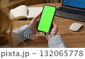 Woman use digital tech cell phone open green screen mock up. Hand press click phone web site middle center. Girl hold mobile. Turn on chroma key page. Cozy home background. Online app copy space. 132065778