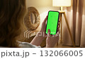 Woman use digital tech cell phone green screen mock up talk video call. Hand swipe click phone web site middle center. Girl hold mobile. Chroma key page. Cozy home background. Online app copy space. 132066005