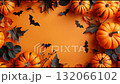 Celebrate Halloween with creative pumpkin and bat decorations on a vibrant orange backdrop 132066102
