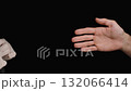 A Doctor's Assistant Helps Put on Latex Gloves for Protection. Black Background. 132066414
