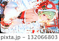 Christmas image: A beautiful girl in a Santa costume printed on a flag. Snow falling and swaying in the wind. Vertical material. Loopable. 132066803