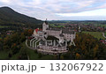 Atmospheric aerial of Schloss Hohenaschau, Bavaria, fog covers the forest below Kampenwand peak and rocky Laubenstein. Schloss im Nebel, bewolkter Tag, Alpenlandschaft, Chiemgau 132067922