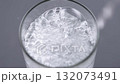 Close-up of water being poured into a glass, creating bubbles and turbulence. Concept of hydration, detox, refreshment and healthy lifestyle. 132073491