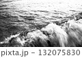 Gentle waves crash on sandy shore of Canj in Montenegro as the morning sun casts a soft glow. The tranquil Mediterranean landscape invites relaxation and peace. Black-white monochrome high contrast 132075830