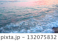 Waves softly lap at the sandy beach of Canj in Bar, Montenegro as the sun rises over the Mediterranean. The tranquil morning atmosphere invites relaxation and reflection 132075832